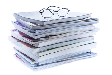 magazine and book stack with glasses