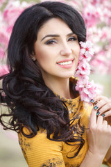 Beautiful woman in spring flowers park