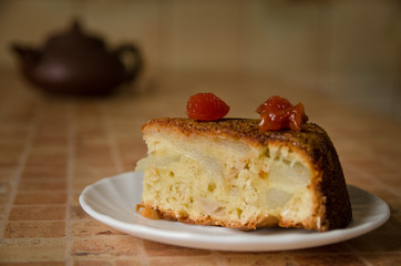 Slice of apple cake topped with cherries