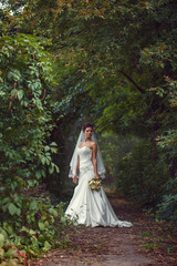 Fototapeta premium bride with a bouquet in the hand