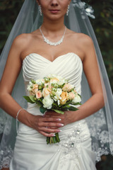 bride with a bouquet in the hand