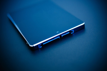 SSD disk drive in blue technological background - tilt-shift