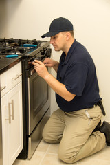 Service technician repairs oven