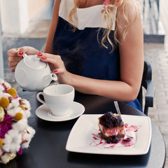 a beautiful young blond girl in summer dress at the table in pav