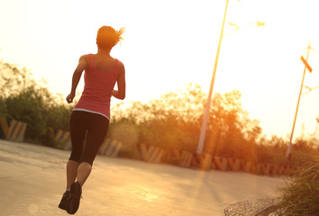 fitness young asian woman running mountain road