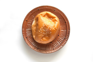 delicious bun with sesame seeds isolated on white