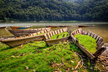 Fototapeta na wymiar Old obsolete fishing boats at the lake