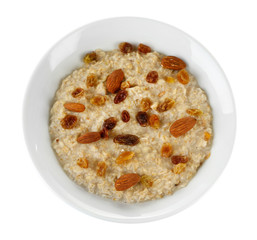 Tasty oatmeal with raisins isolated on white
