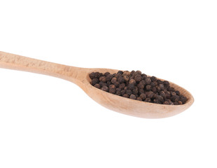 close up of black peppercorns on a wooden scoop