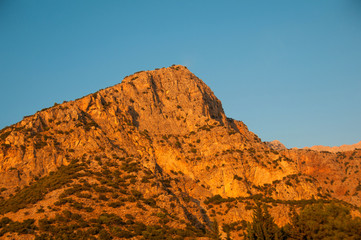 Turkey, Babadag mountain at sunset on a background of blue sky.