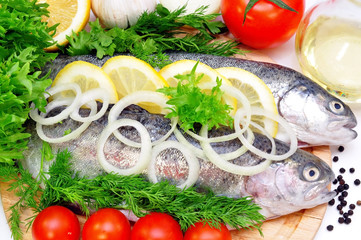 two rainbow trout with lemon and fresh vegetables