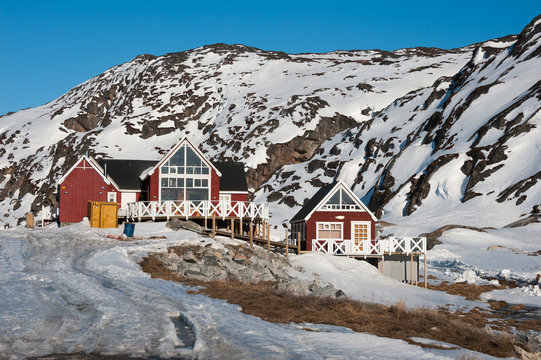 Wooden house, with snowy mountain in Ilulissat, Greenland