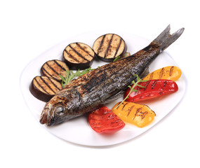 Grilled seabass with vegetables on plate.