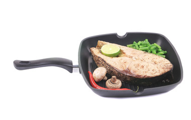 Grilled carp steak on pan.