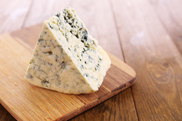 Tasty blue cheese, on wooden table