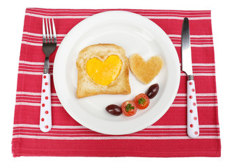 Scrambled eggs with bread on plate, on color napkin