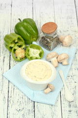 Delicate mushroom sauce in bowl on wooden table close-up