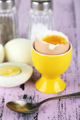 Boiled eggs on color wooden background