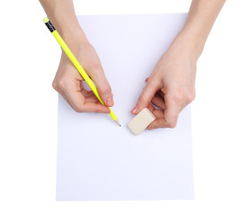 Human hands with pencil and erase rubber, isolated on white