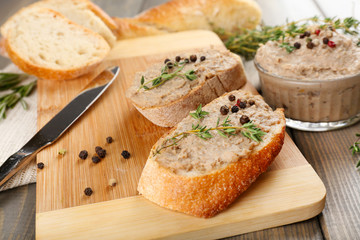 Fresh pate with bread on wooden table