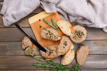 Fresh pate with bread on wooden table