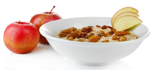 Tasty oatmeal with raisins and apples isolated on white