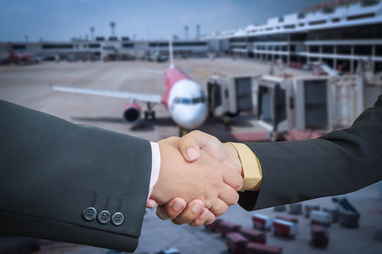 Businessman handshake with air plane transportation logistic bac