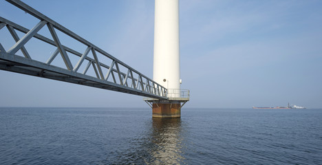 Fototapeta premium Wind turbine in a lake along a dike