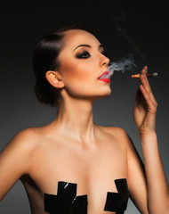 Portrait of a beautiful woman with cigar and with a glamorous re