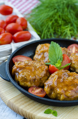 fishcakes in tomato sauce in a cast iron skillet