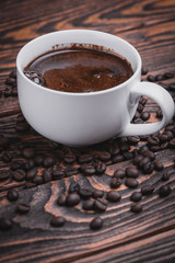 cup of hot coffee on wood background