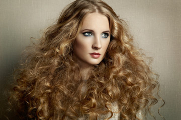 Fototapeta premium Portrait young beautiful woman with curly hair