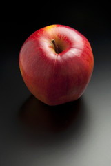 Red apple on dark gray background
