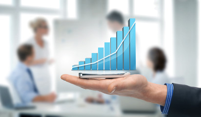 hand holding smartphone with virtual chart