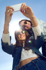 Selfie girls taking photos with a smartphone
