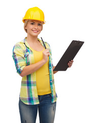 smiling woman in helmet with clipboard