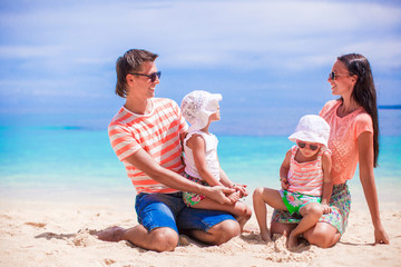 Portrait beautiful caucasian family of four on tropical vacation