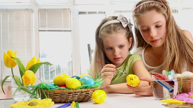 	Children paint Easter eggs at home.