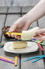 Preparing chocolate dipped bananas dessert