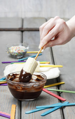Preparing chocolate dipped bananas dessert