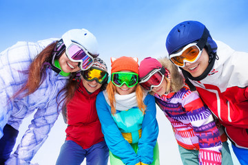 Happy friends posing with goggles