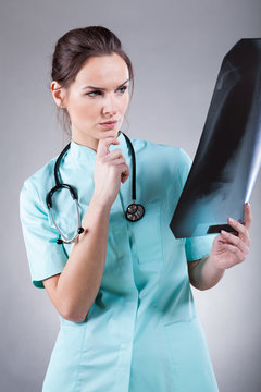 Female doctor looking at X-ray scan