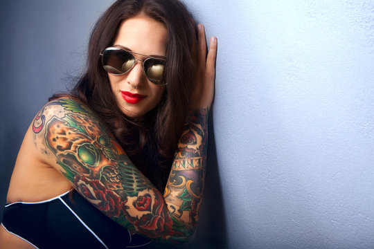 Beautiful girl with stylish make-up and tattooed arms,,