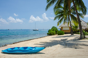 Obraz na płótnie Canvas Blue kayak on beach on a tropical island