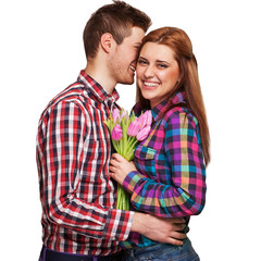 Young couple in love holding a bouquet of tulips. 