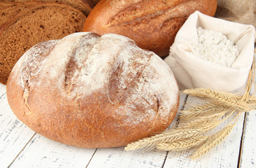Rye bread with flour on table close up