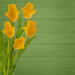 Beautiful bouquet of  tulips on green wooden background