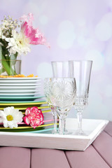 Stack of colorful ceramic dishes and flowers,