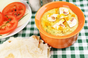 Bowl of tasty fresh hummus with tomatoes
