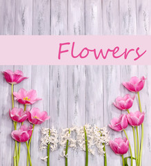 Obraz premium Beautiful flowers on wooden background